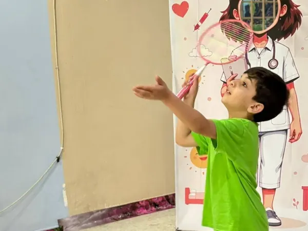 A child playing badminton during an activity at Nurtaqwa Kindergarten.